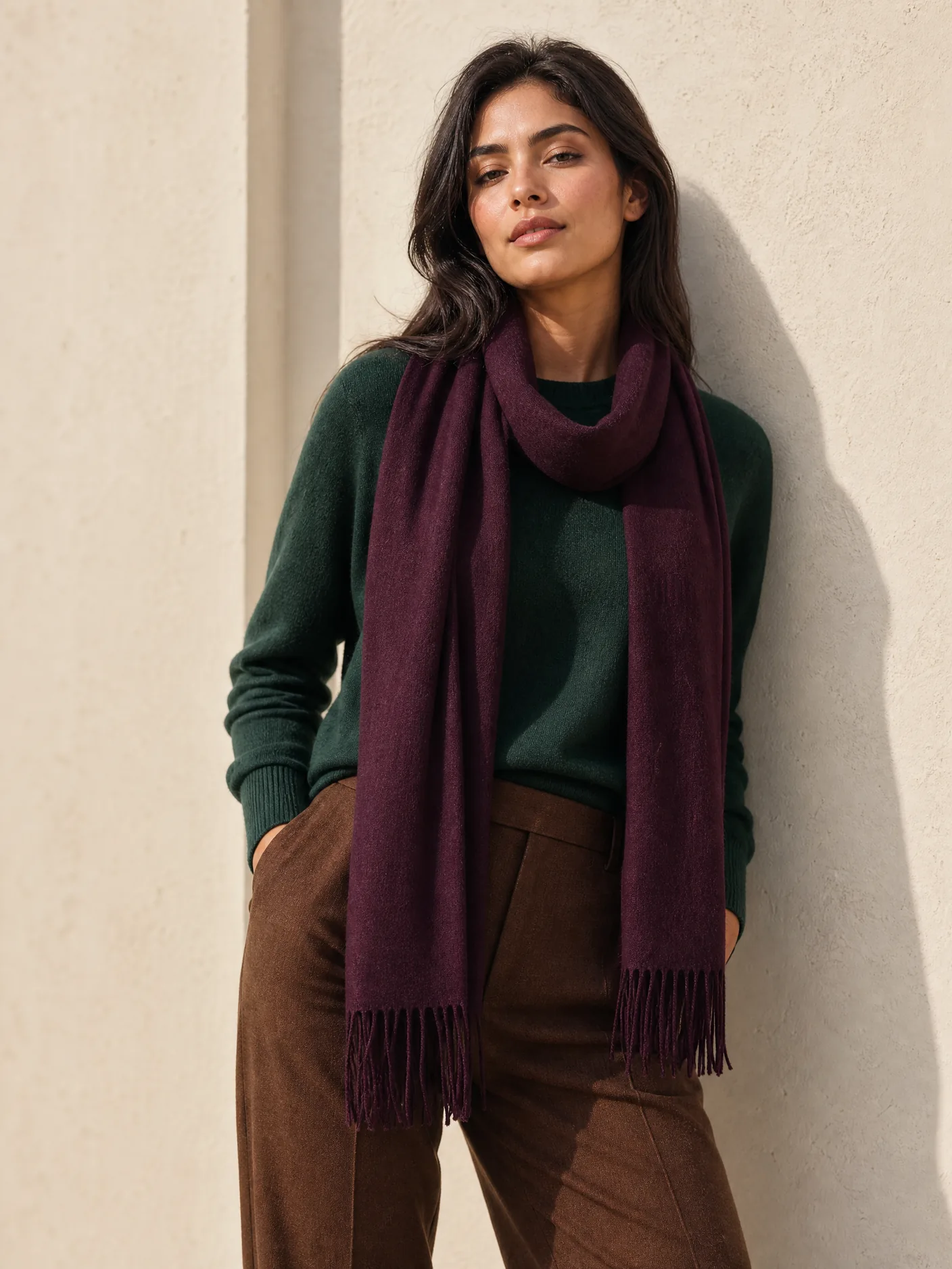 Illustration: a green sweater, tobacco trousers and a plum cashmere scarf